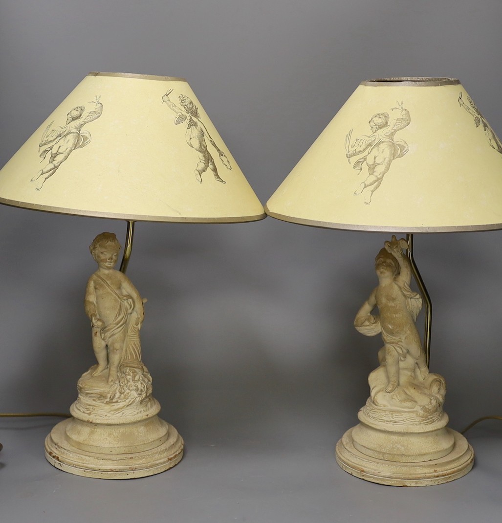 A pair painted composition cherub lamps on plinth base, altogether 43cm tall